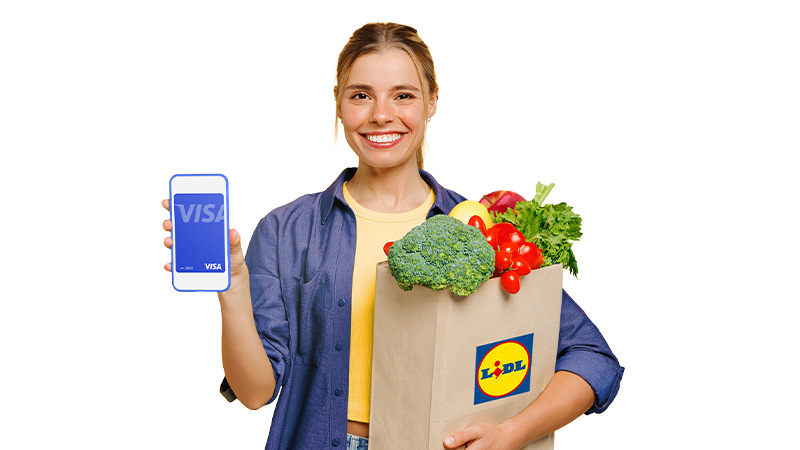 woman carrying phone and lidl shopping