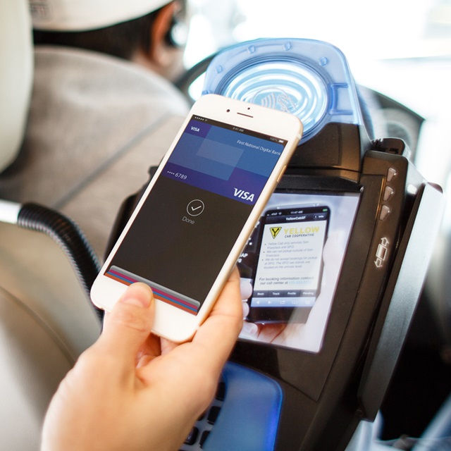 person using mobile payment in taxi